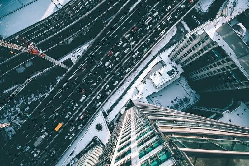 Looking down on a busy city freeway and glass towers